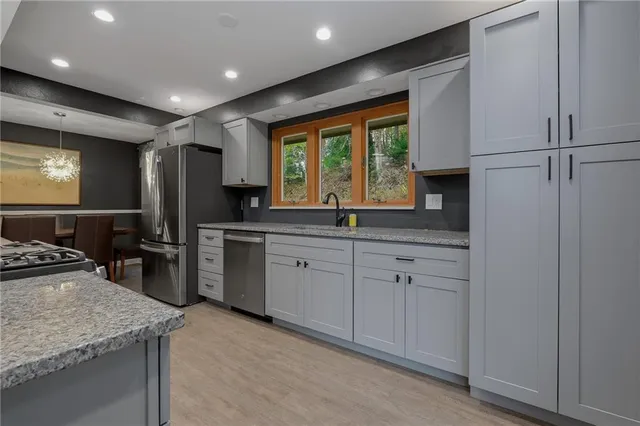 a kitchen with a sink stove and refrigerator