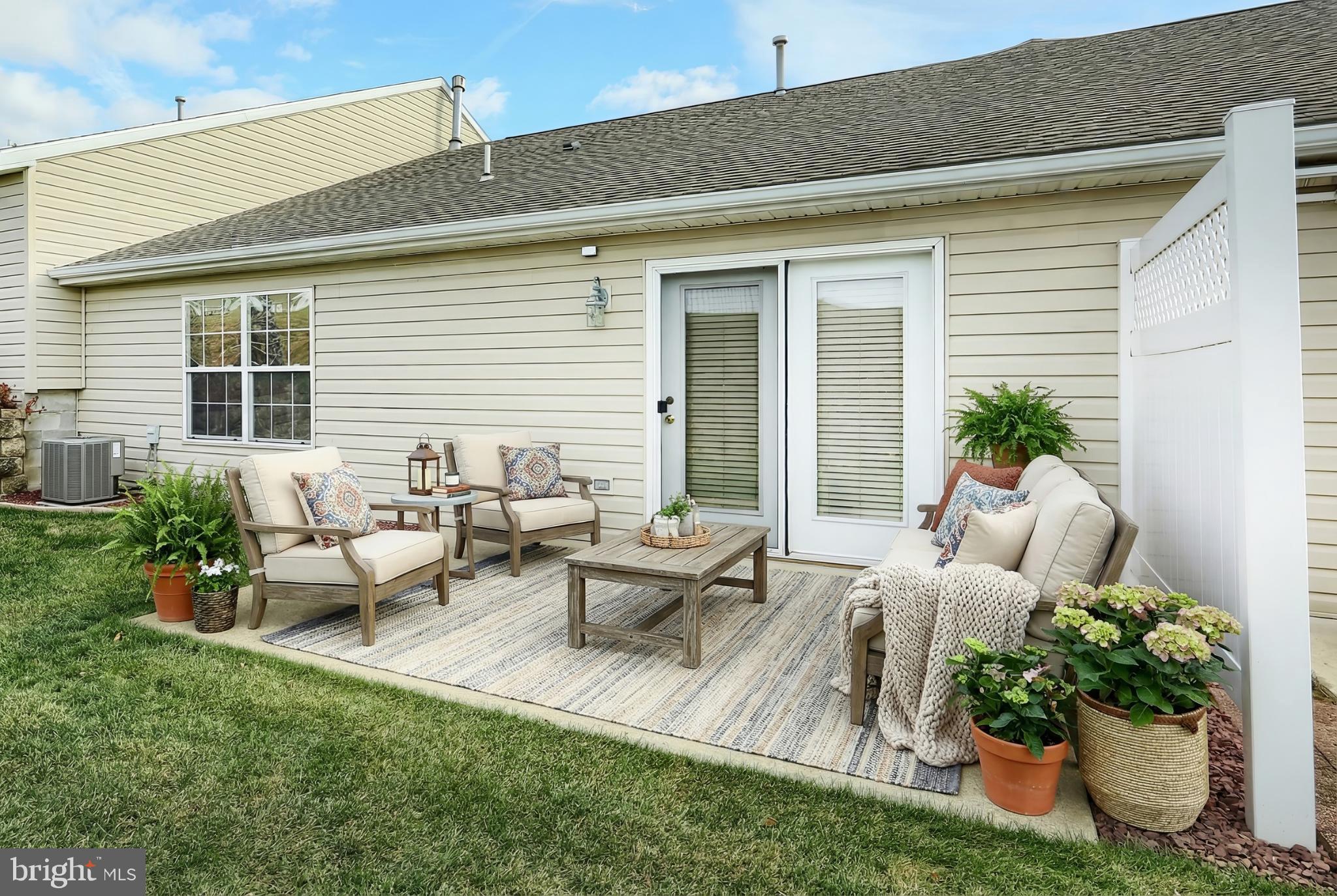 121 Furlong Way, Unit 121 Red Lion, PA 17356 - Photo 27 of 31 a living room with furniture potted plant and windows