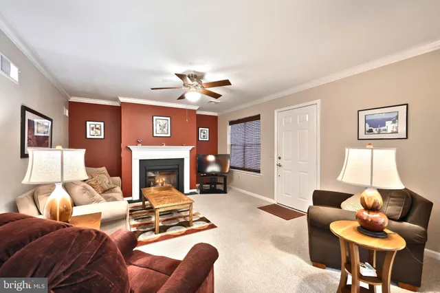 a living room with furniture a fireplace and a chandelier