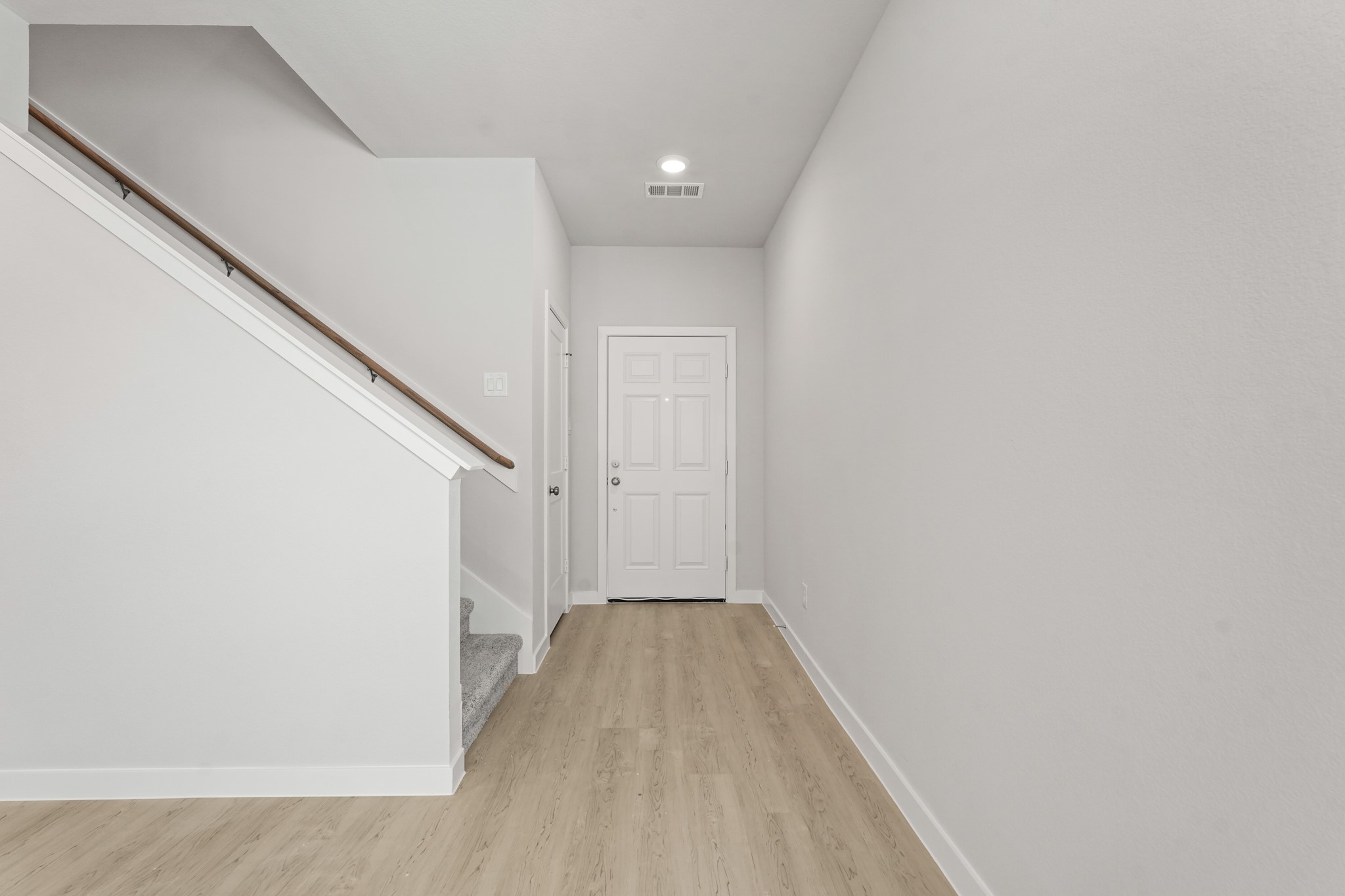 217 Spring Drive Hockley, TX 77447 - Photo 3 of 27 a view of a hallway with wooden floor and staircase