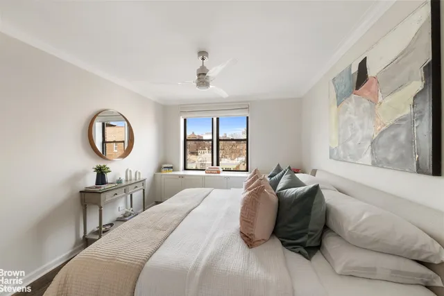 a bedroom with a large bed and a large window