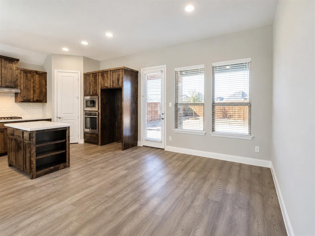 6209 Cupleaf Road Flower Mound, TX 76226 - Photo 15 of 29 Kitchen and dining space featuring wood-finish flooring, recessed lighting, and a kitchen island with a light-toned countertop