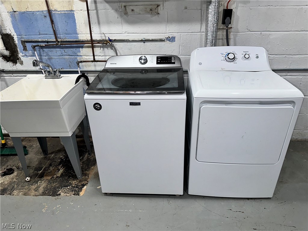 7495 Johnnycake Ridge Road Mentor, OH 44060 - Photo 42 of 50 Laundry room featuring washer hookup, electric dryer hookup, and washing machine and dryer