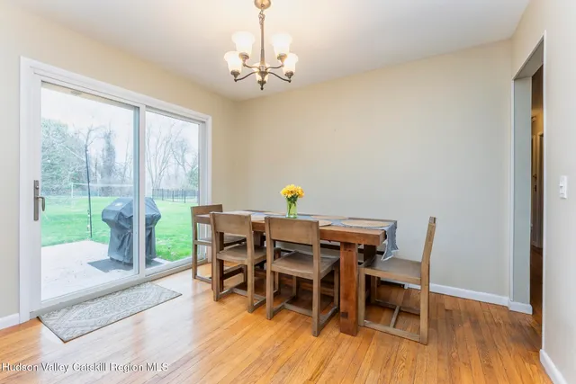 a view of a dining room with furniture wooden floor and chandelier