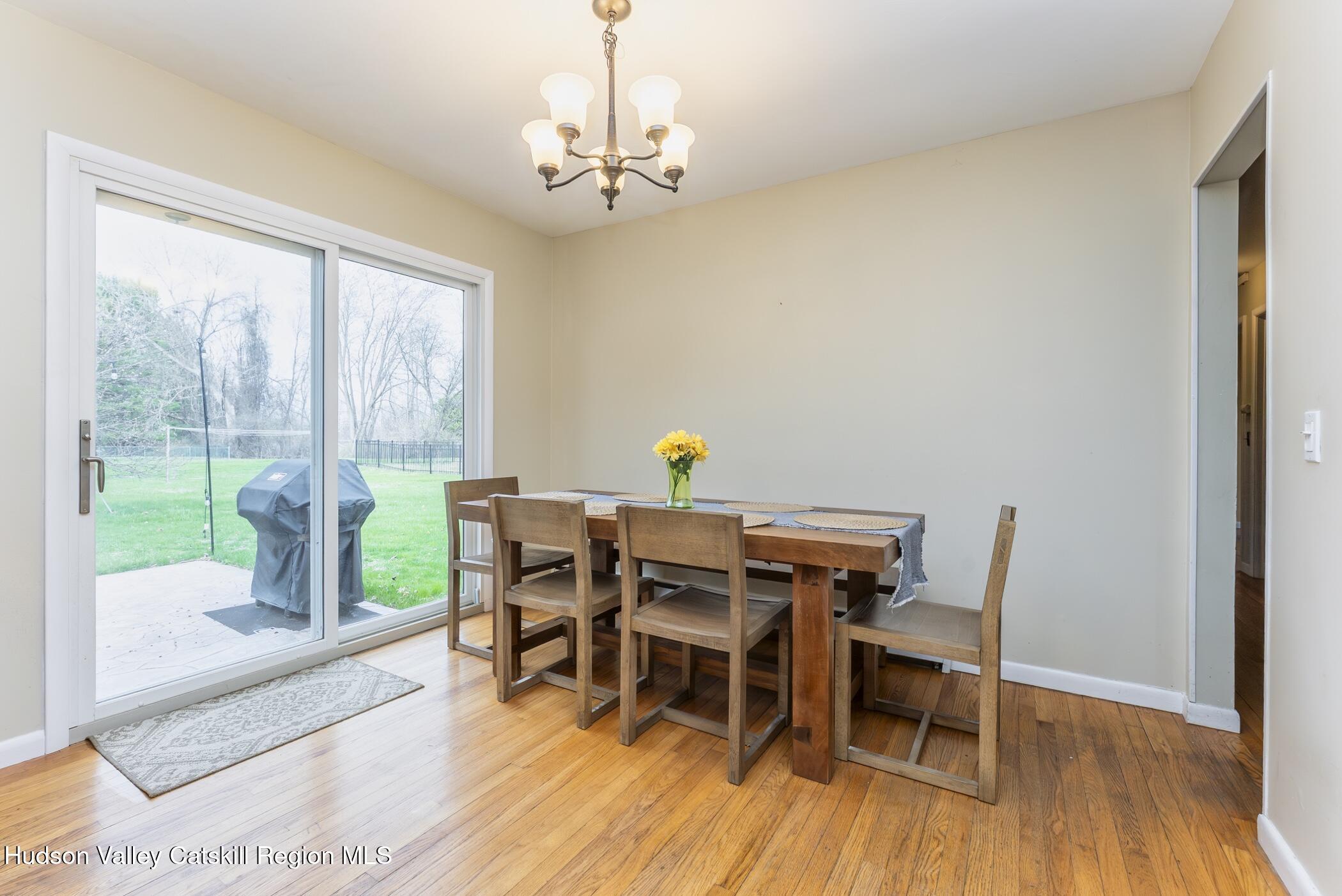 121 Rayna Street Hurley, NY 12443 - Photo 11 of 41 a view of a dining room with furniture wooden floor and chandelier