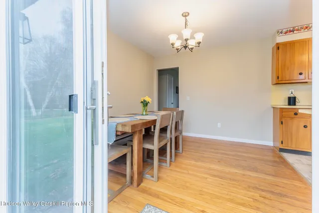 a view of a dining room with furniture and chandelier