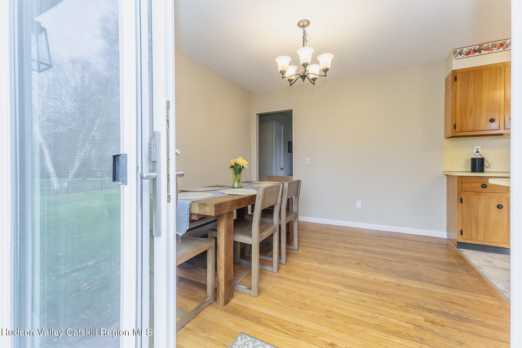 121 Rayna Street Hurley, NY 12443 - Photo 12 of 41 a view of a dining room with furniture and chandelier