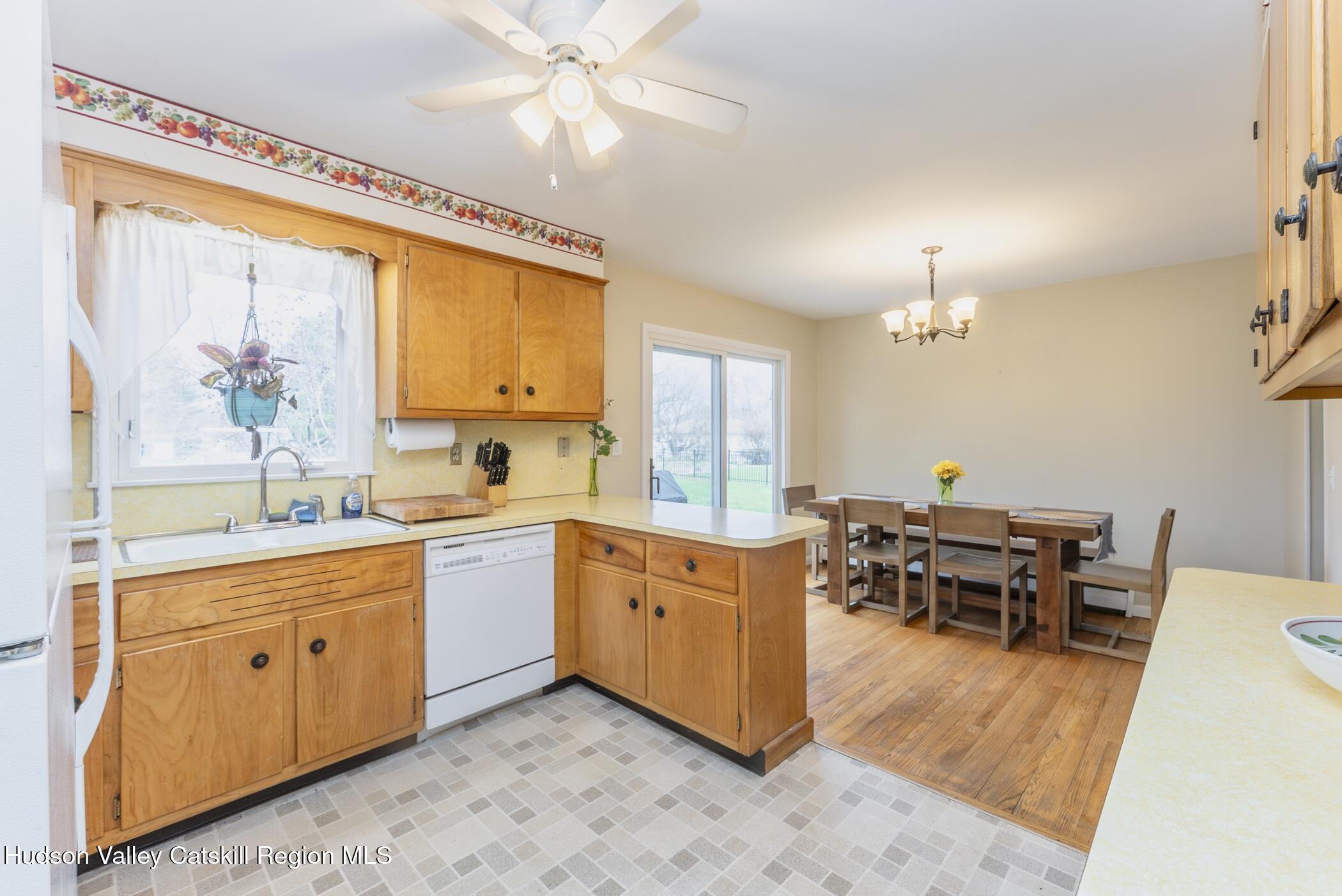 121 Rayna Street Hurley, NY 12443 - Photo 15 of 41 a open kitchen with stainless steel appliances granite countertop a stove and a wooden cabinets