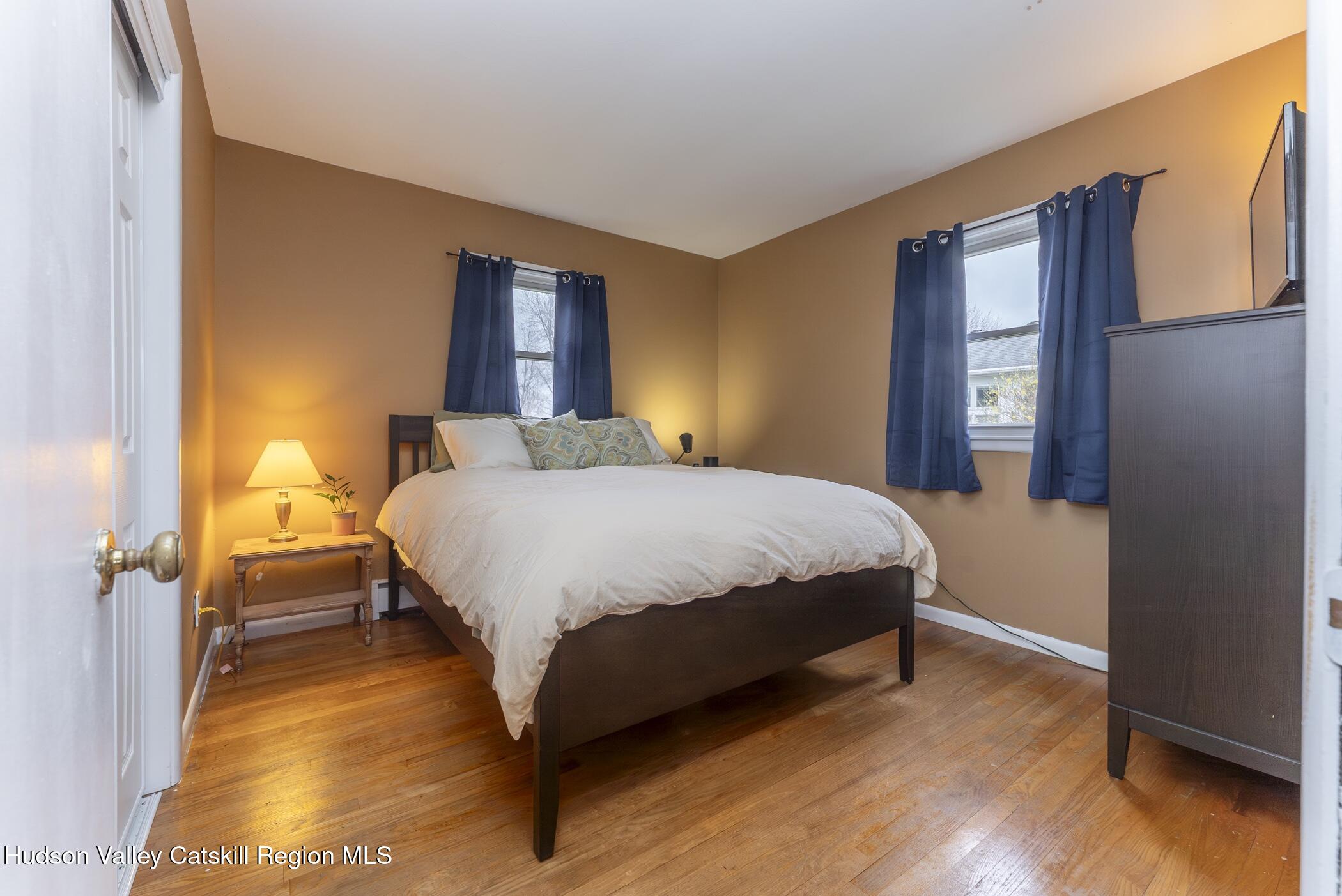 121 Rayna Street Hurley, NY 12443 - Photo 20 of 41 a bedroom with a bed and wooden floor