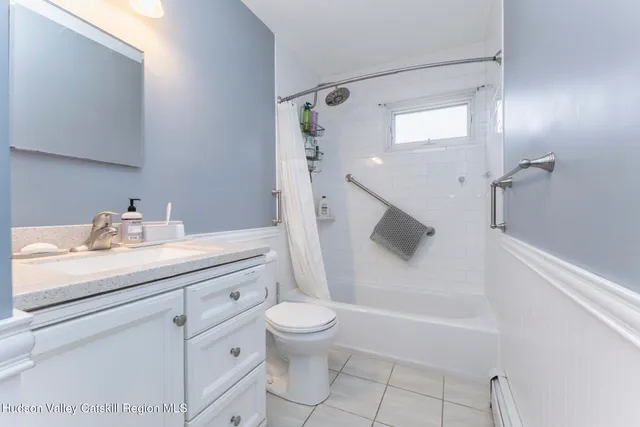 a bathroom with a sink vanity and a mirror