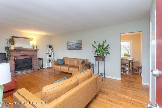 a living room with furniture a fireplace and a table