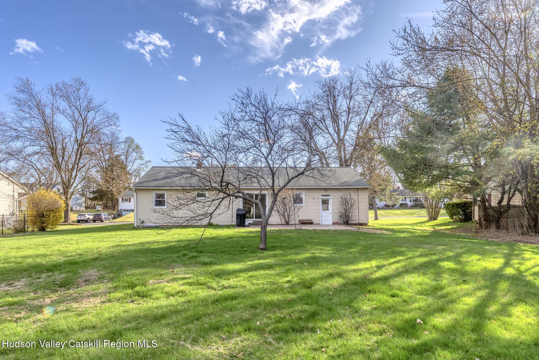 121 Rayna Street Hurley, NY 12443 - Photo 37 of 41 a yellow house with a big yard and large trees