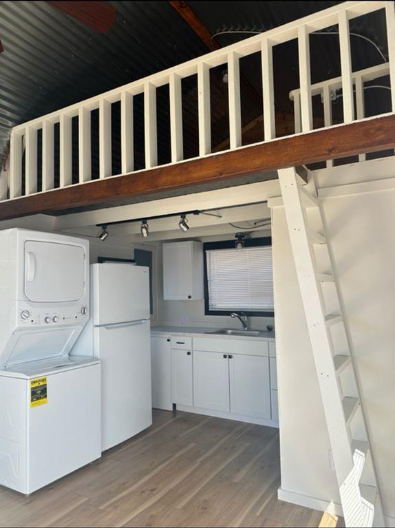 4135 Farm To Market 902 Howe, TX 75459 - Photo 8 of 8 a view of washer and dryer with wooden cabinets