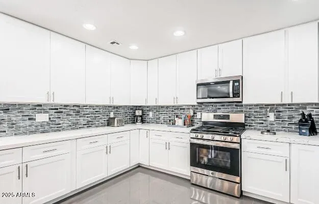 a kitchen with appliances a sink and cabinets