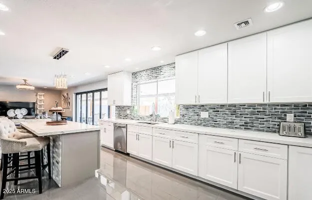 a kitchen with a sink window and cabinets