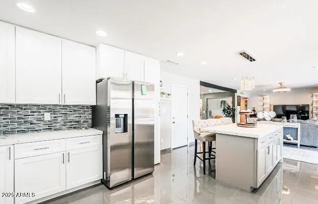 a kitchen with stainless steel appliances a refrigerator sink and cabinets