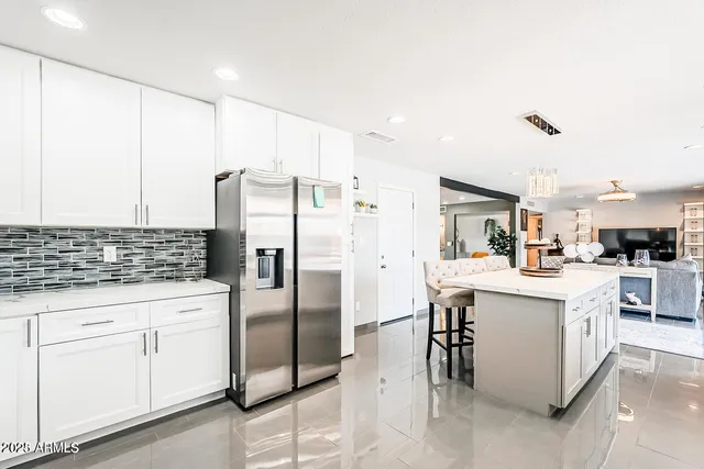 a kitchen with cabinets and stainless steel appliances
