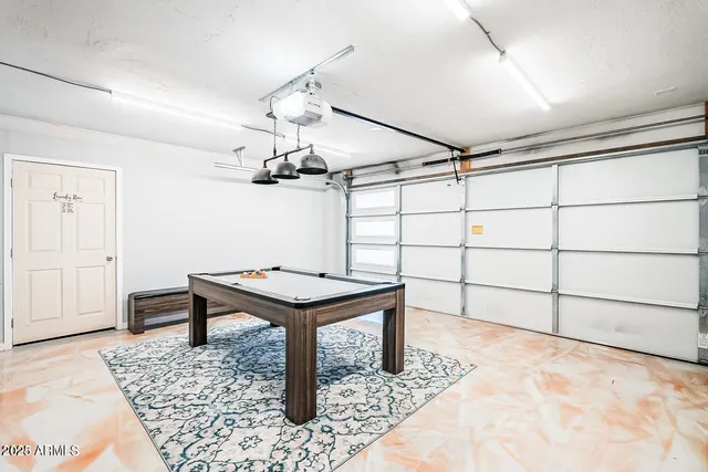 a room with lots of wooden cabinets and glass table