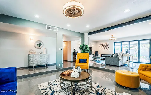 a living room with furniture and a wooden floor