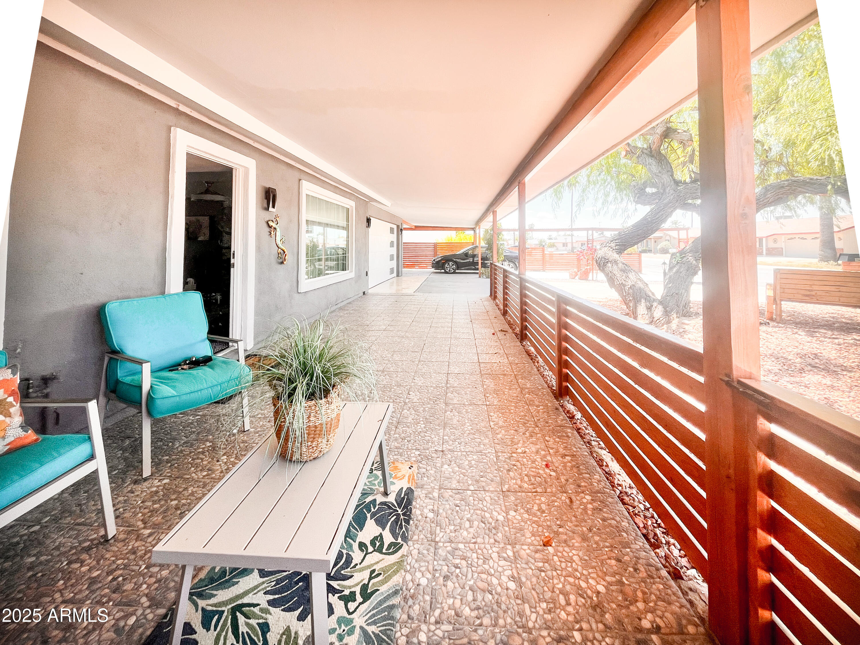 11215 North 37th Avenue Phoenix, AZ 85029 - Photo 28 of 46 a porch with a table and chairs next to a large window