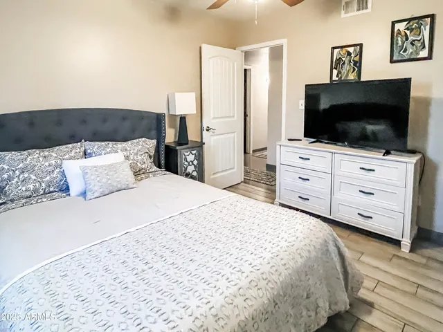 a bedroom with a bed and a flat screen tv