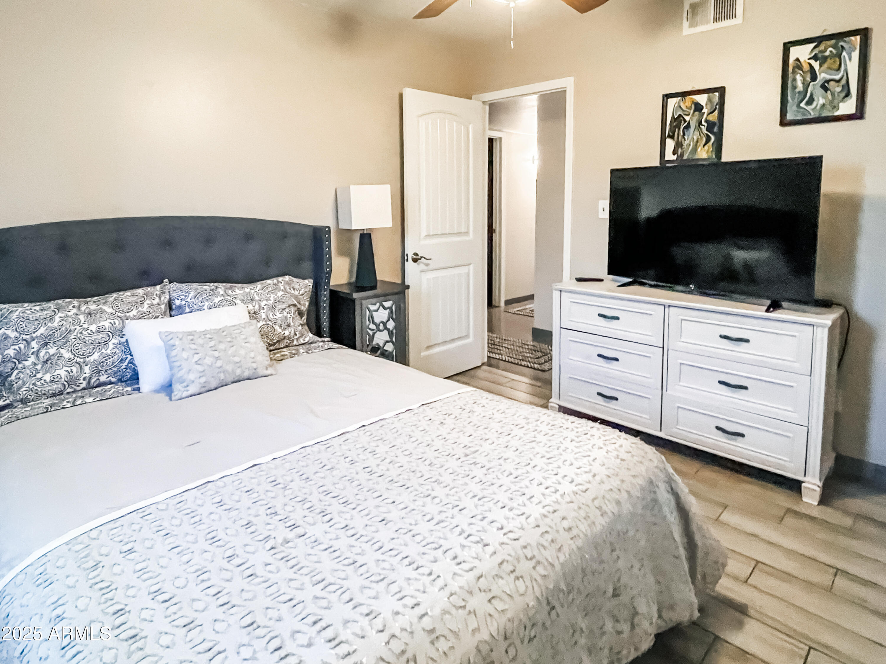 11215 North 37th Avenue Phoenix, AZ 85029 - Photo 31 of 46 a bedroom with a bed and a flat screen tv