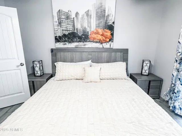 a bedroom with a bed and a window