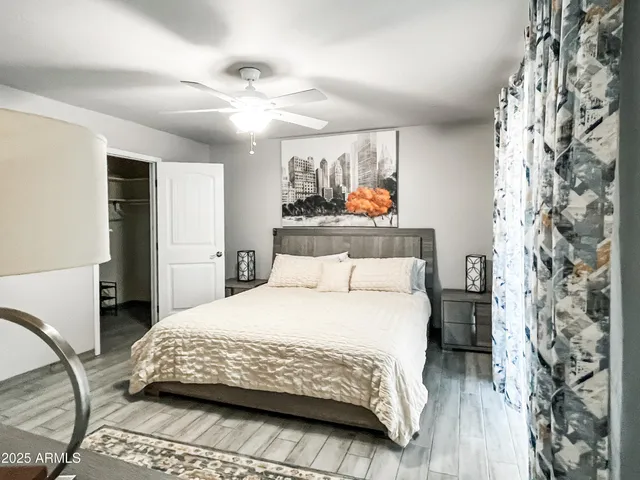 a bedroom with a bed and a chandelier