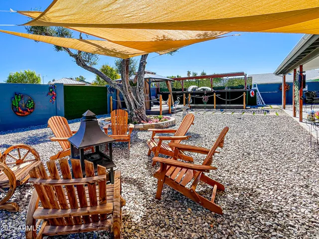 a view of a patio with table and chairs potted plants