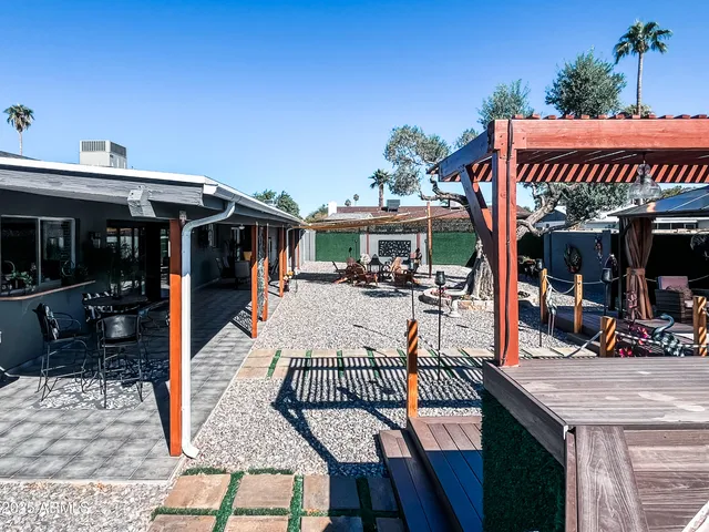 a view of a patio with swimming pool table and chairs