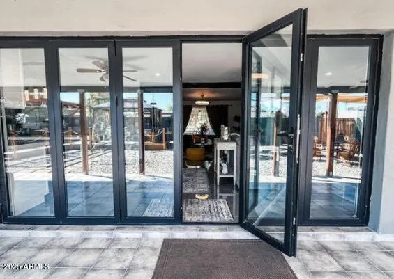 a view of a hallway with wooden floor and a glass door