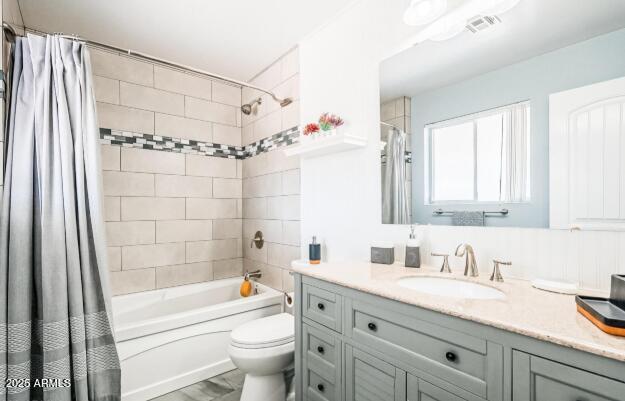 11215 North 37th Avenue Phoenix, AZ 85029 - Photo 8 of 46 a bathroom with a granite countertop sink a toilet a mirror a vanity a bathtub and shower