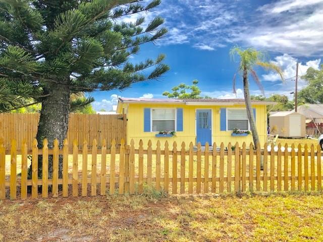 2234 Northeast Pine Ridge Street Jensen Beach, FL 34957 - Photo 11 of 16 a view of a brick house with a large windows