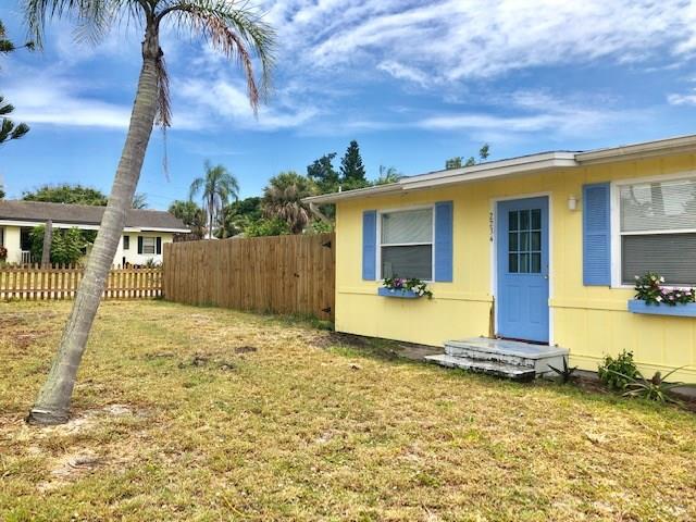 2234 Northeast Pine Ridge Street Jensen Beach, FL 34957 - Photo 12 of 16 a view of a house with backyard and roof