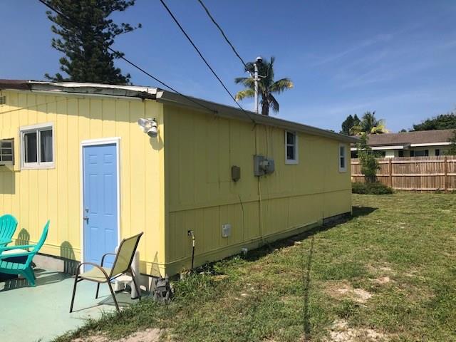 2234 Northeast Pine Ridge Street Jensen Beach, FL 34957 - Photo 14 of 16 a backyard of a house with table and chairs