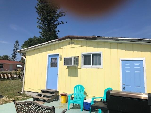 2234 Northeast Pine Ridge Street Jensen Beach, FL 34957 - Photo 16 of 16 a front view of a house with a yard
