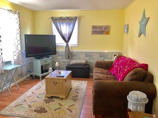 2234 Northeast Pine Ridge Street Jensen Beach, FL 34957 - Photo 3 of 16 a living room with furniture and a flat screen tv