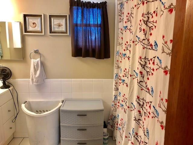 2234 Northeast Pine Ridge Street Jensen Beach, FL 34957 - Photo 6 of 16 a bathroom with a sink and a washing machine