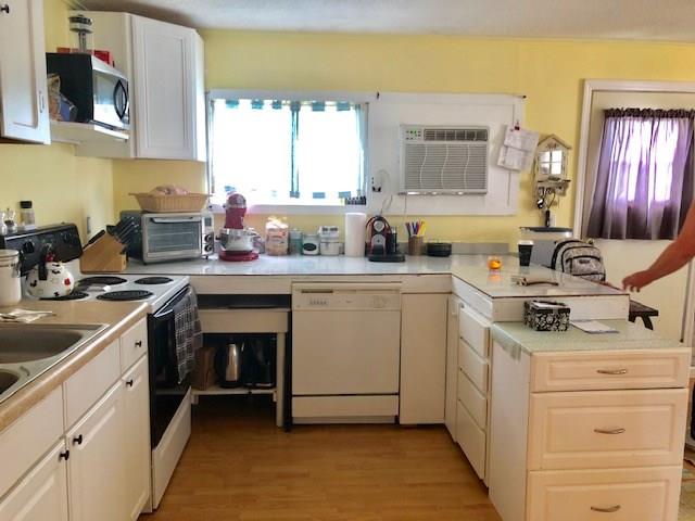 2234 Northeast Pine Ridge Street Jensen Beach, FL 34957 - Photo 7 of 16 a kitchen with a sink stove and cabinets