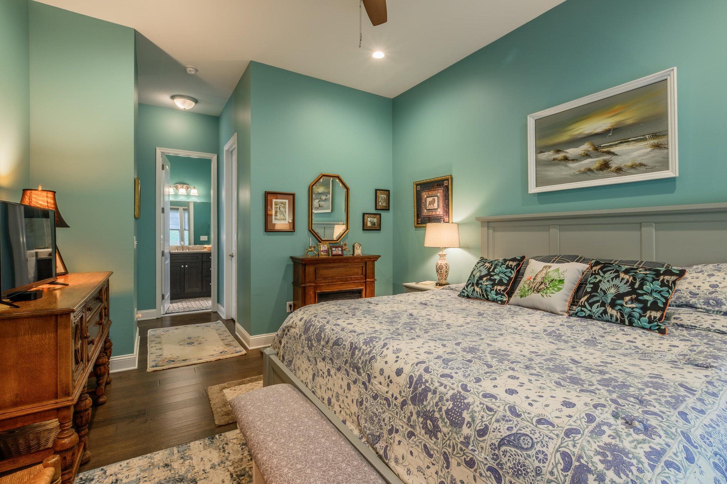 41 Chamberlain Loop Lexington, VA 24450 - Photo 25 of 43 a bedroom with a large bed and a chandelier