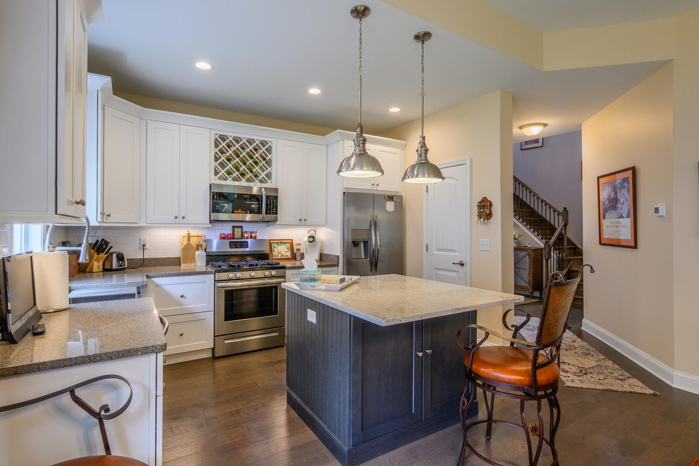 41 Chamberlain Loop Lexington, VA 24450 - Photo 9 of 43 a kitchen with stainless steel appliances granite countertop a stove top oven a refrigerator a sink and chairs
