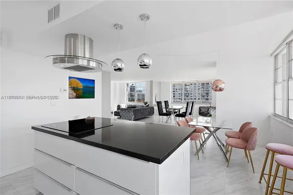 a living room with furniture a chandelier and a flat screen tv
