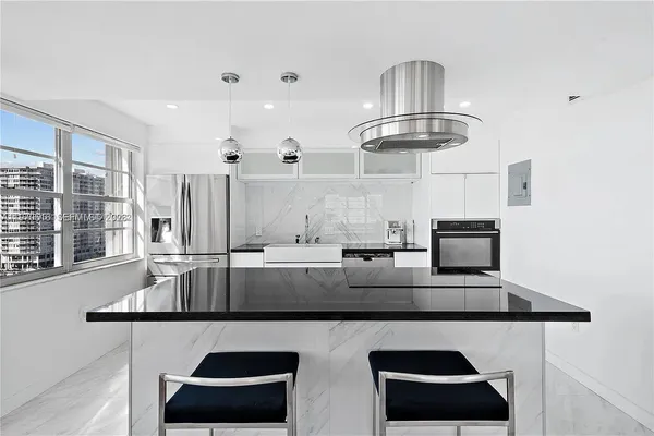 a kitchen with stainless steel appliances granite countertop a sink and a stove