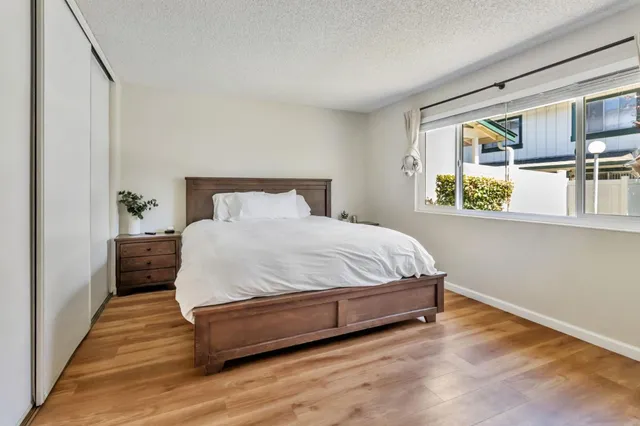 a spacious bedroom with a bed and a large window