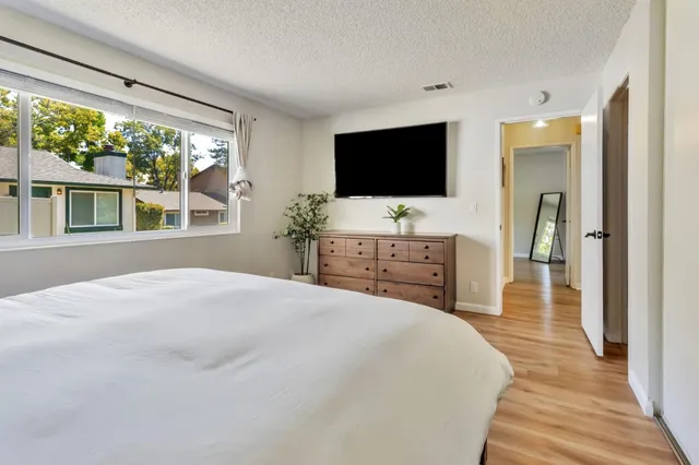 a bedroom with a bed and a flat screen tv
