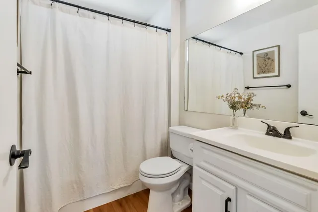 a bathroom with a sink a toilet and a mirror