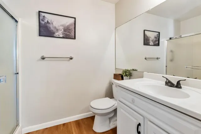 a bathroom with a sink a toilet and mirror