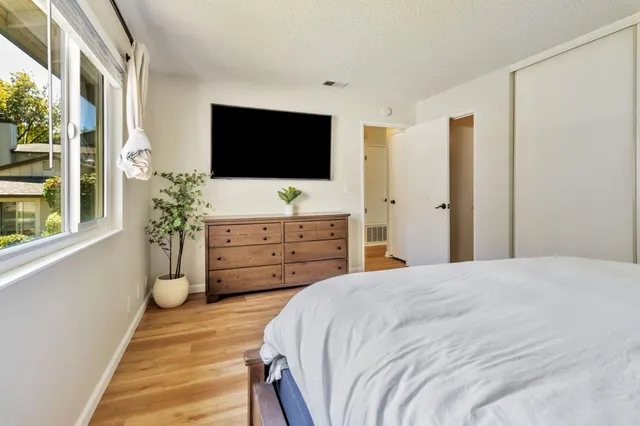 a bedroom with a bed and a flat screen tv