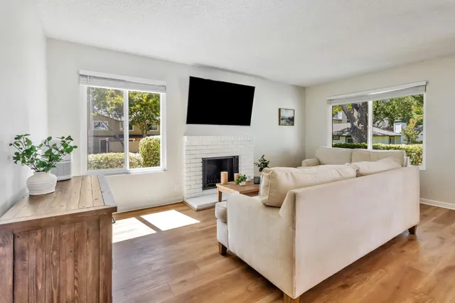 a living room with furniture fireplace and window