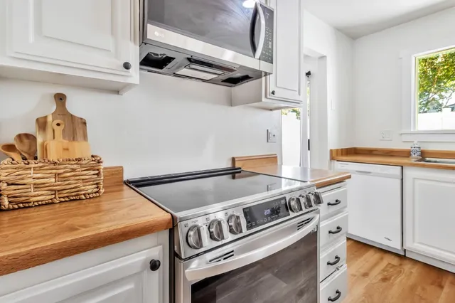 a stove top oven sitting inside of a kitchen